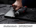 Man Holds Screwdriver In Hands Close-Up