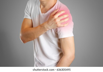 A man holds the shoulder. The pain in my arm. Sore point highlighted in red. Closeup. Isolated.