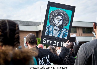 A man holds a sign with an image of sports icon Colin Kaepernick asking "Get It Yet?" - June 2, 2020: Black Lives Matter Protest at Clifton City Hall - Clifton, NJ 