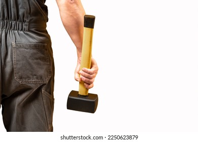 A man holds a sledgehammer in his hand on a white background.