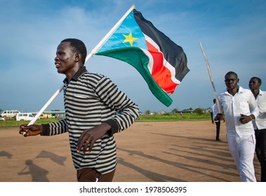 A man holds a South Sudanese flag  in Juba on July 9, 2016 during celebrations as part of the country's fourth independence day. 