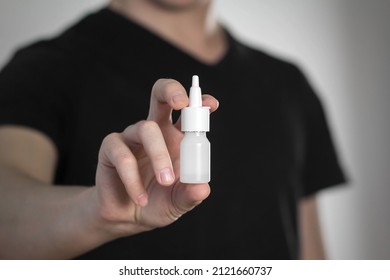 A Man Holds A Spray For A Runny Nose. Close Up.