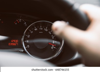 Man Holds Steering Wheel And Speedometer Show Hi Speed