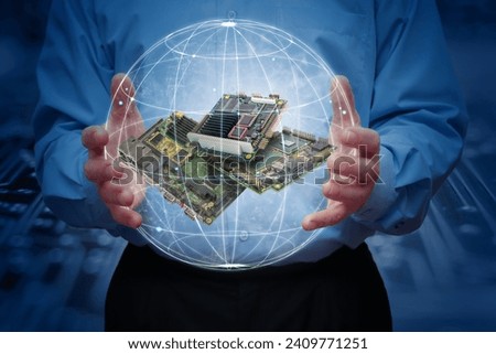 A man holds a stylised, highlighted earth with some industrial embedded CPU boards inside. Concept of Global Industrial Computer Automation.