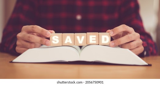 Man holing wooden block word SAVED.Jesus saved me Worship Faith and Read Bible Online at home.Bible study in home church, Good friday, Easter, Thanksgiving, Worship and Christian.Prayer pray.Gospel. Man holing wooden block word SAVED.Jesus saved me Worship Faith and Read Bible Online at home.Bible study in home church, Good friday, Easter, Thanksgiving, Worship and Christian.Prayer pray.Gospel.