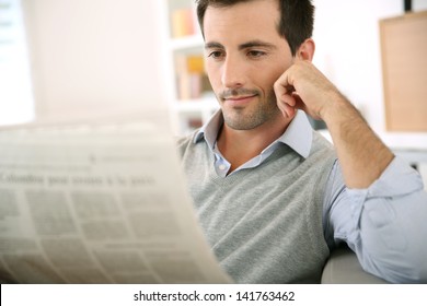 Man At Home Reading Newspaper