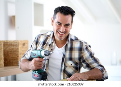 Man At Home Using Electric Drill