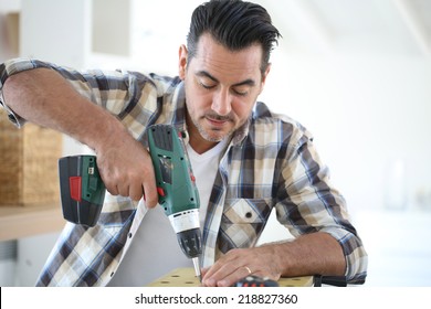 Man At Home Using Electric Drill