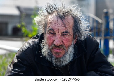 Man hommeless, vagrant beggar on street city. Surgut, Russia - 25, May 2021.
