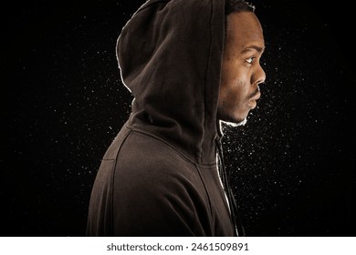 Man in Hoodie Against a Starry Backdrop - Powered by Shutterstock