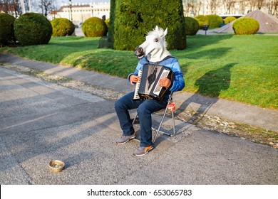 Man With A Horse Head Street Musician Playing The Accordion Outdoors, Funny Prank