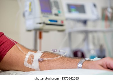 Man In Hospital Getting An Immunoglobulin Infusion With Intravenous Drip