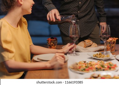 A Man Host Pouring A Wine To His Guests At Home Dinner Party.