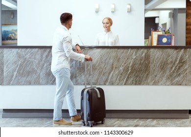 Man At Hotel Reception.