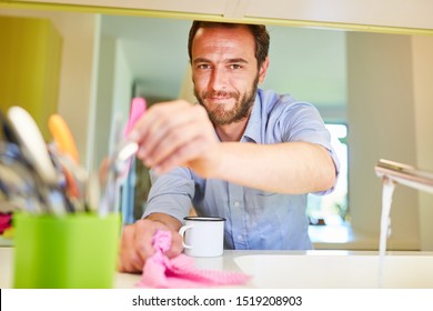 Man As A Houseman Cleaning In The Kitchen As A Concept For Role Reversal