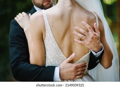 Man Hug Woman. The Bride And Groom Embracing On Wedding Ceremony Of The Outdoor In The Nature Backyard. Goosebumps Appeared On Body Of A Young Bride From Touch Man. Skin Texture. Close Up. Back View.