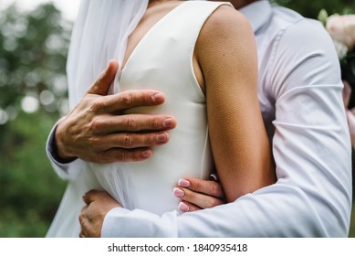 Man Hug Woman. Goosebumps Appeared On Body Of A Young Beautiful Bride From Touch Man. Beautiful Skin Texture. A Groom Gently Embraces Girl In A Wedding Dress By The Shoulders. Close Up.