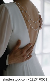 Man Hug Woman. Goosebumps Appeared On Body Of A Young Bride From Touch Man. Skin Texture. Close Up. Back View. Pearls On The Back