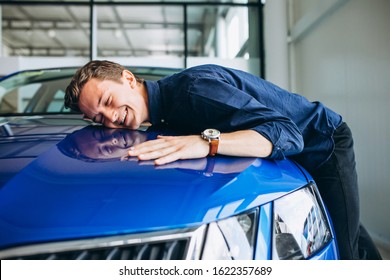 Man Hugging A Car In A Car Showroom