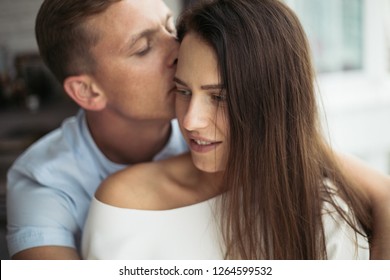 Man Hugging Woman From Behind At Home