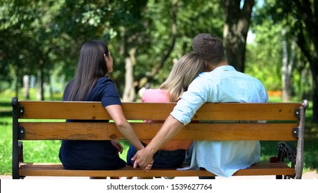 Man hugging woman secretly holding other female hand, secret relations, betrayal