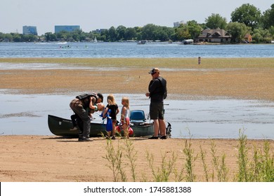 A Man Hugs A Little Girl As The Family Prepares For Boating On Medicine Lake, Plymouth, MN. 5/31/20