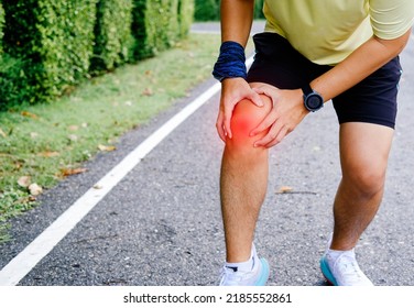 Man Hurts Knee From Long Distance Running In Park.