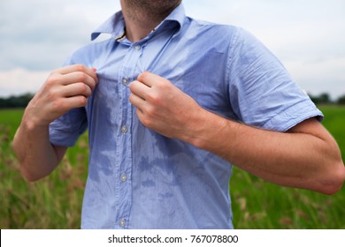 Man with hyperhidrosis sweating very badly under armpit in blue shirt because of hot weather. Travelling in asia thailand with backpacker