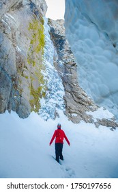 Man in ice cave with mountain view