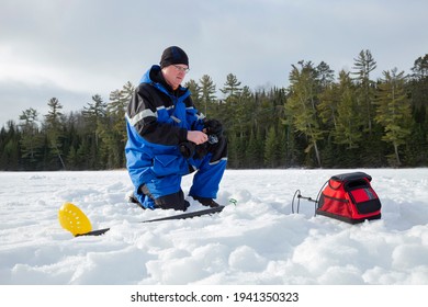 Man Ice Fishing On A Northern Minnesota Lake On A Winter Morning