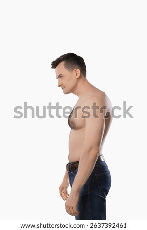 Man with incorrect posture posing on light grey background