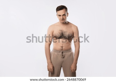 Man with incorrect posture posing on light grey background