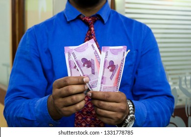 a man with indian currency 