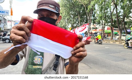 a man with Indonesian flag, red and white. Jakarta, 1 August 2021.