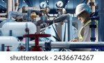 Man is industrialist. Worker with laptop inside chemical factory. Equipment for production of toxic substances. Industrialist guy in hardhat. Industrial equipment and pipes around man