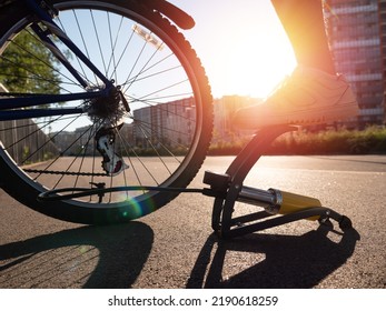 Man Inflating Bike Tire Outdoors. Pumping Up Bicycle Tyre. Closeup
