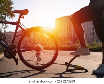 Man Inflating Bike Tire Outdoors. Pumping Up Bicycle Tyre. Closeup
