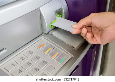 Man Is Inserting Card To Atm Machine To Withdraw Or Transfer Money