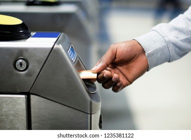 Man Inserting A Subway Pass