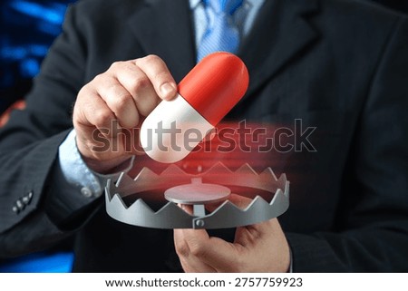 A man inserts a medication capsule into a trap. Drug addiction and medical collusion highlighting pharmaceutical abuse regulatory failure and healthcare ethics concerns.