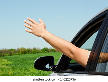 Man inside car showing his hand outdoor