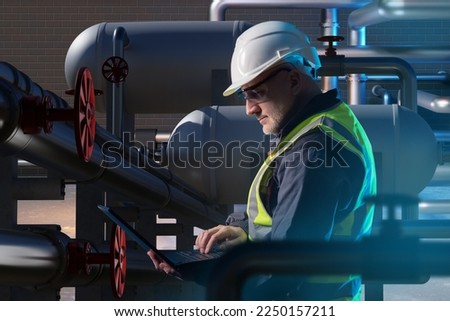 Man inside oil refinery. Factory manager with laptop. Inspector controls process of oil refining. Oil refinery pipes and equipment near man. Inspector in helmet and yellow vest. Fuel factory