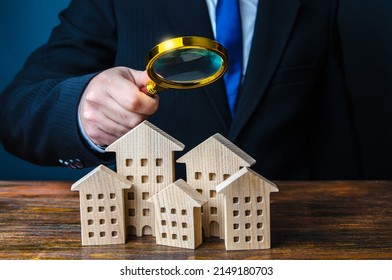 A man inspects houses. Search for real estate for sale offers. Property valuation. Audit and revision of the city. Checking the effectiveness of the work of authorities and city services.