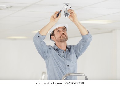 a man installing cctv camera