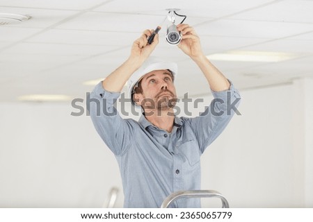 a man installing cctv camera