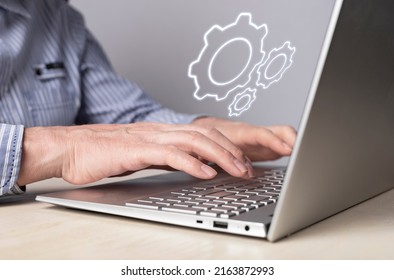 Man installing, configuring system settings at laptop. Computer repair, technical support concept. Sysadmin or IT administrator profession. High quality photo