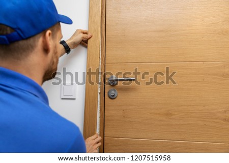 man installing door architrave