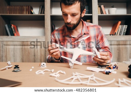 Man installing drone propellers. Building of flying quadrocopter. Modern technologies, innovation, hobby, aeromodelling concept