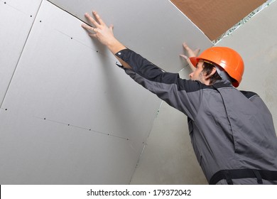 Man Installing Drywall Gypsum Panels