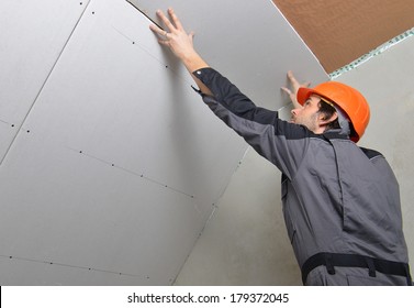 Man Installing Drywall Gypsum Panels